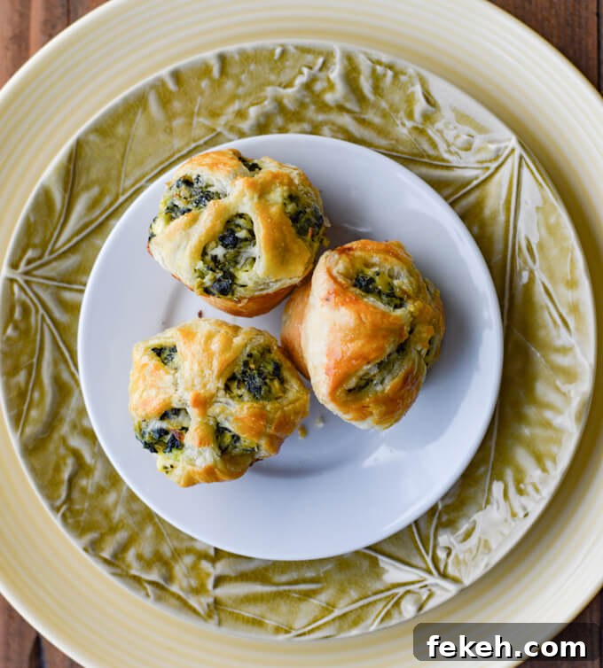 Spinach Puff Pastry Bites: Flaky Savory Appetizer Recipe 7 Three Spinach and Feta Puff Pastry Appetizers sitting on several stacked plates.