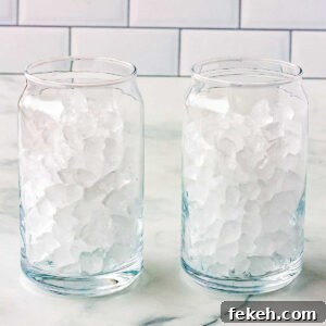 Pebble ice in two clear drinking glasses.