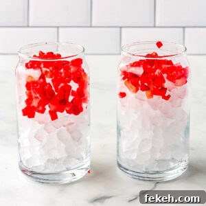 Frozen chopped strawberries added to thge glasses.