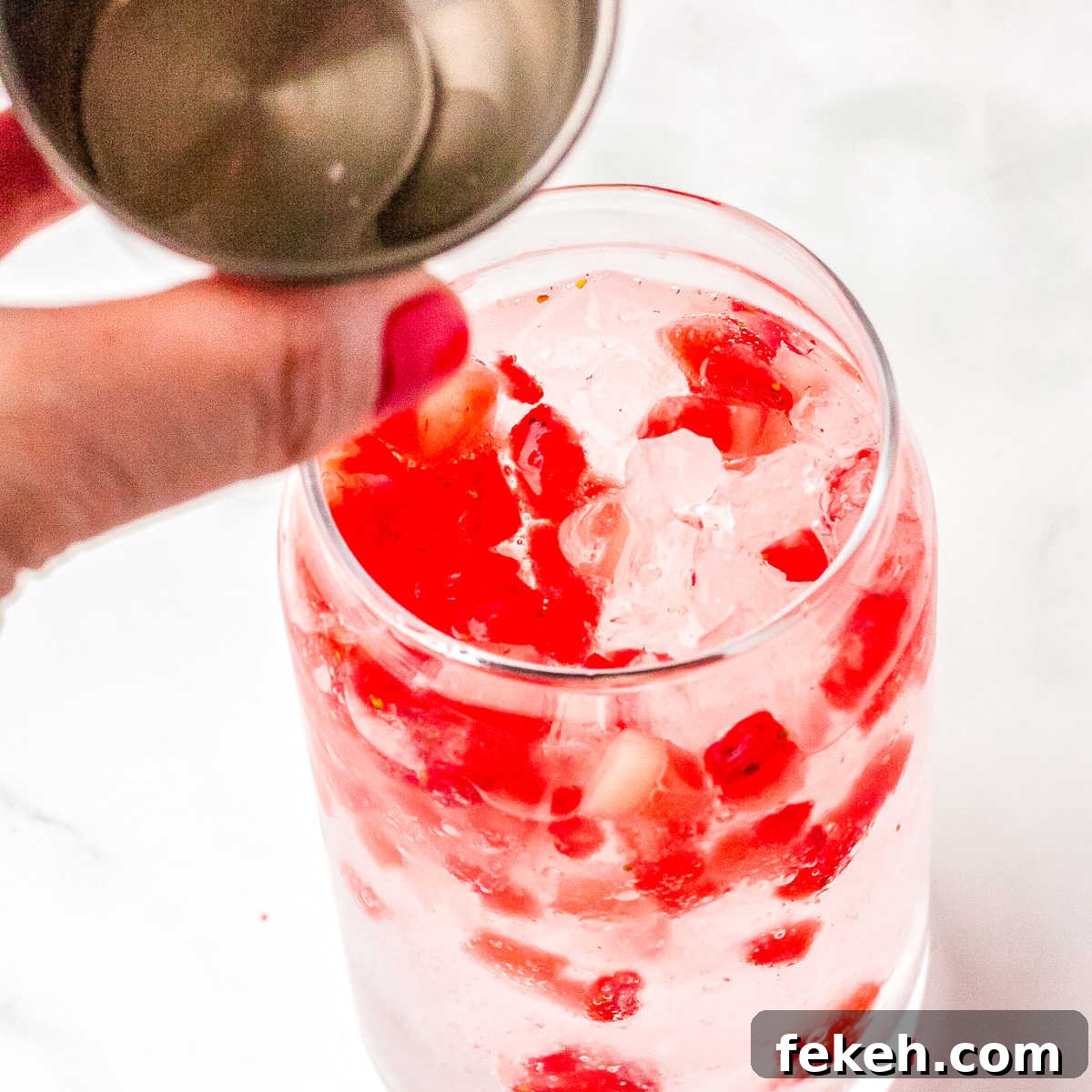 Vanilla and coconut syrup being poured into the glasses.