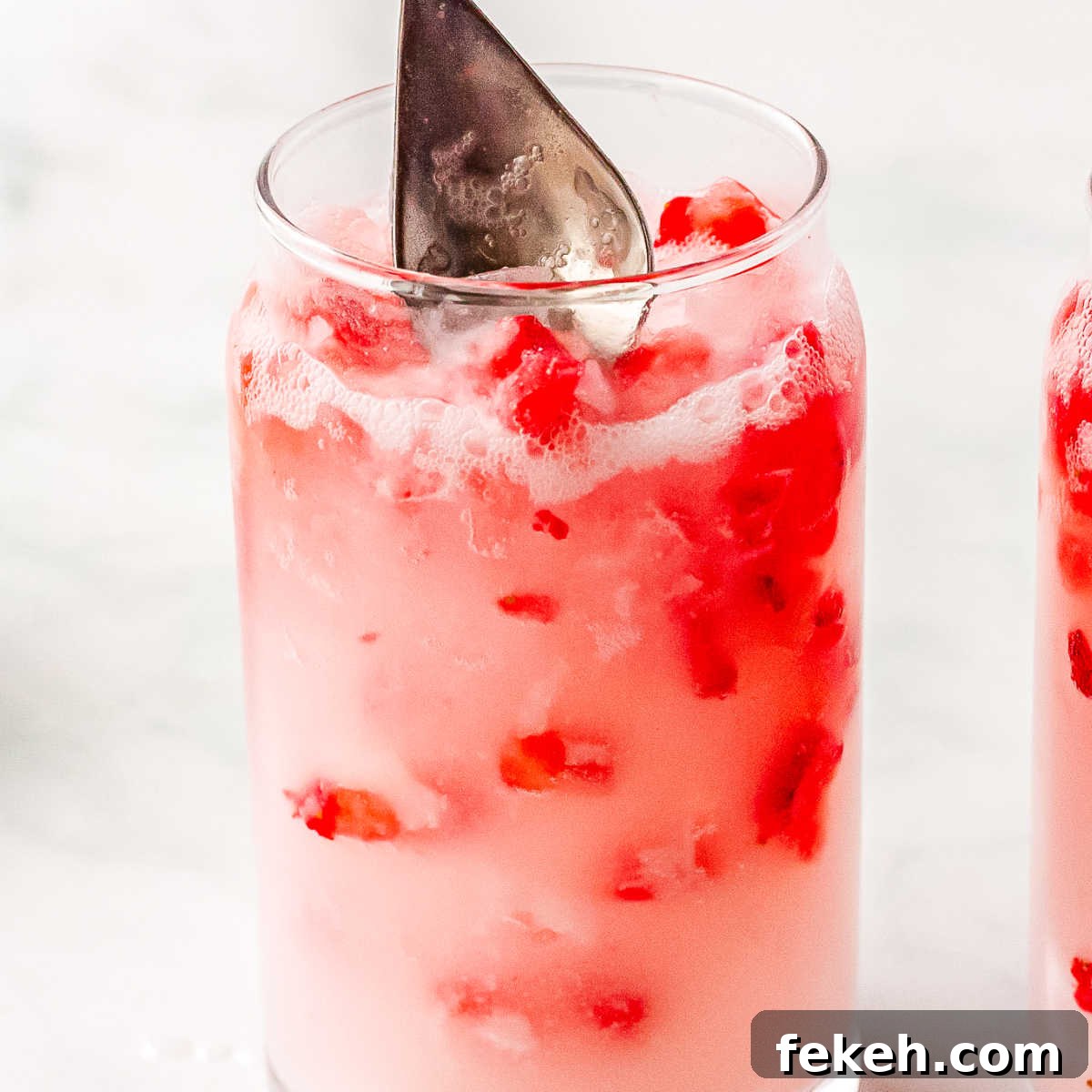 Coconut creme and strawberry puree stired in the glasses.