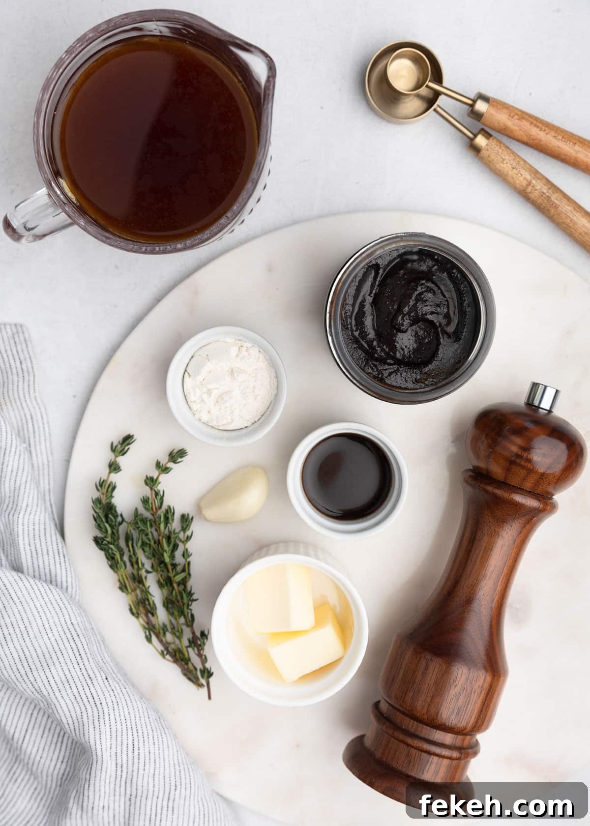 overhead photos of the ingredients needed to make beef jus on a marble board