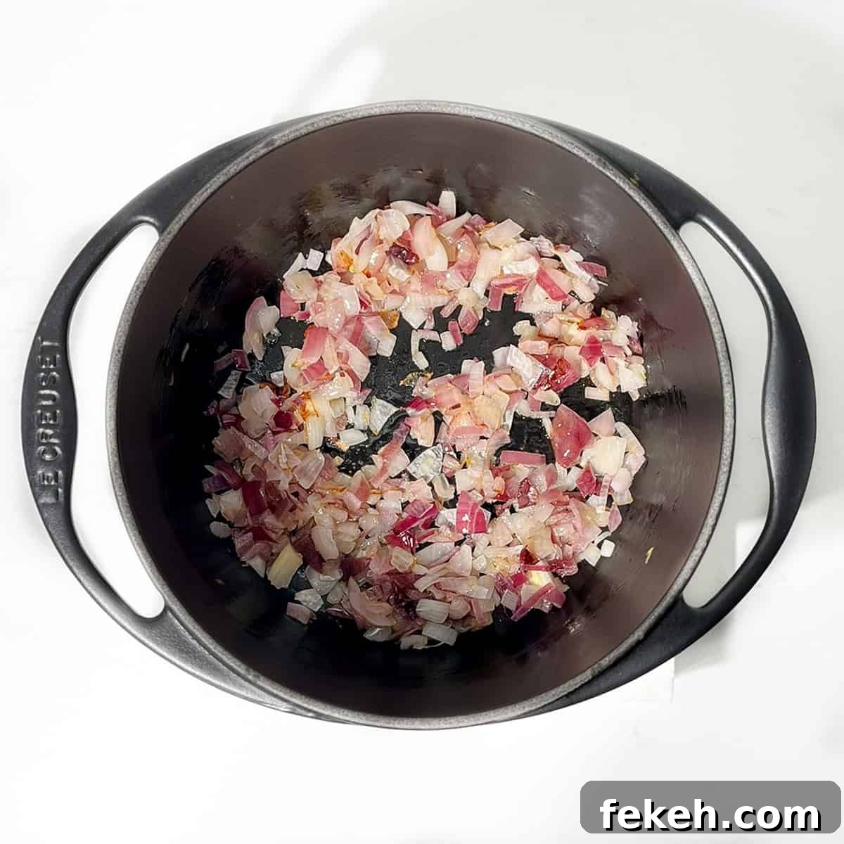Majestic Moroccan Rice Pilaf with Saffron and Aromatic Spices 5 Frying onions in a black cast iron saucepan.