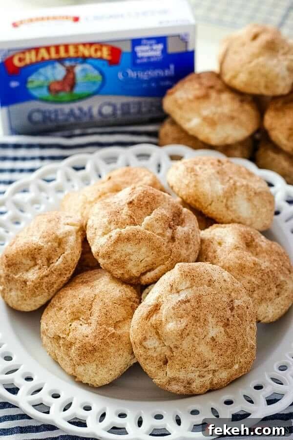 Snickerdoodle Cream Cheese Cookies piled up on a white plate.