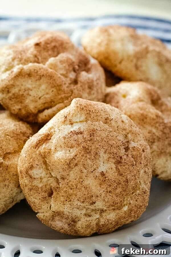 Snickerdoodle Cream Cheese Cookies piled on a white plate close up.