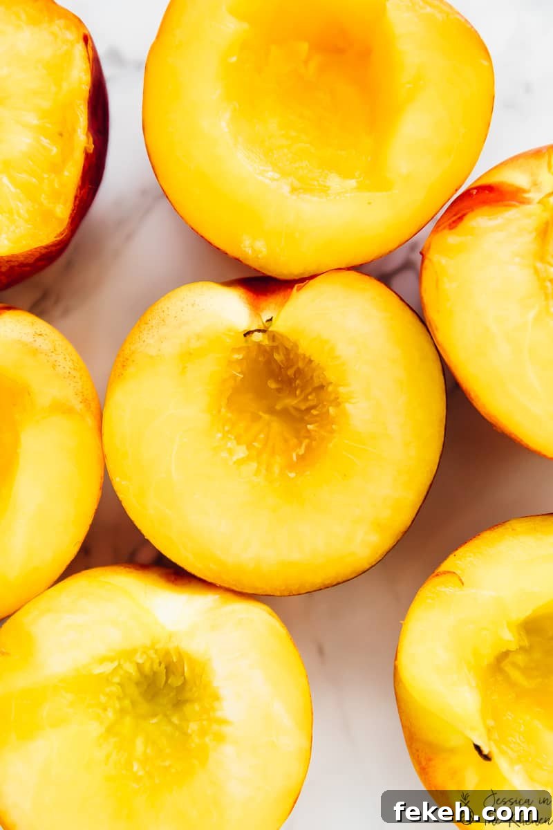 Peaches cut into halves with the pits removed, ready for the grill.