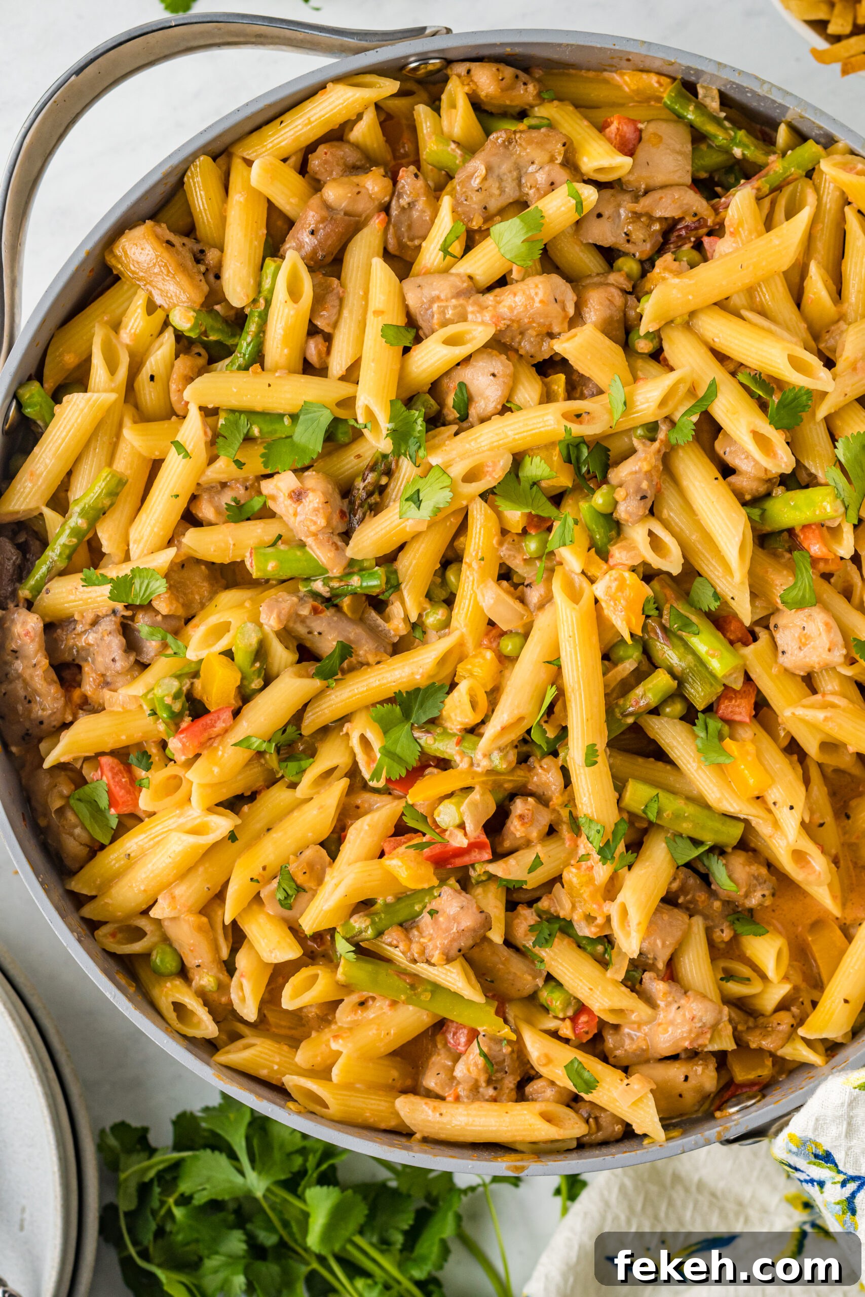 Cajun Chicken Pasta Recipe with Creamy Parmesan Sauce 3 Overhead view of Cajun Chicken Pasta in a frying pan.