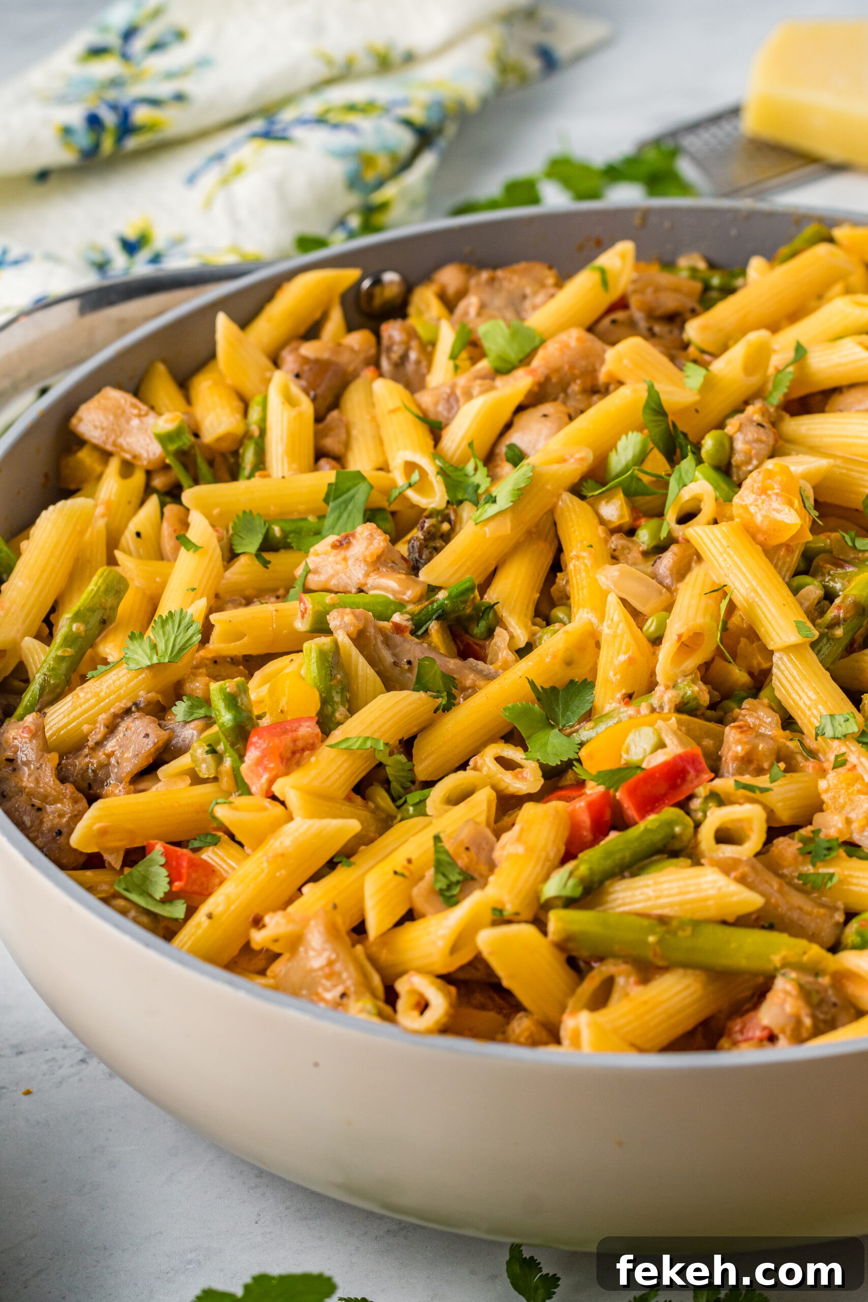 Cajun Chicken Pasta Recipe with Creamy Parmesan Sauce 4 Side view of Cajun Chicken Pasta in a frying pan.