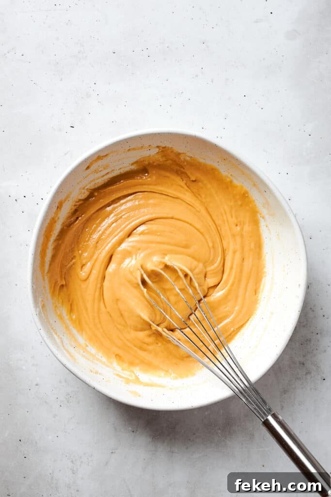 Blonde Brownies | Vanilla Blondies with White Chocolate and Pecans! A whisk incorporates all of the ingredients into the batter to make blonde brownies.