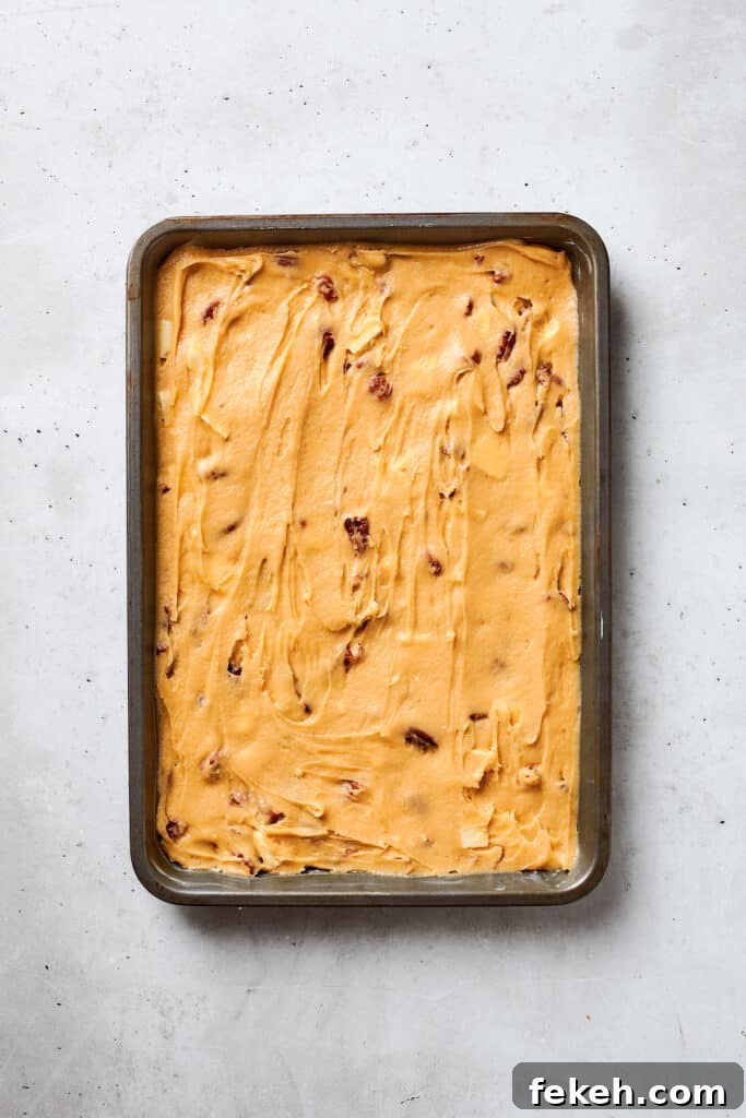 Blonde Brownies | Vanilla Blondies with White Chocolate and Pecans! Blonde brownies batter is spread into a baking pan.