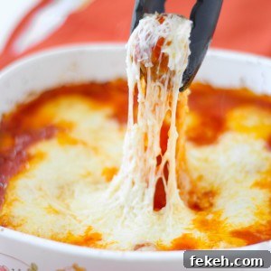 Meatball Parmigiana is cheesy meatballs with tomato sauce baked right in the oven, no mess or frying! Good enough for a fancy dinner to serve for a holiday and is also kid friendly. You’ll Be Head Over Heels For This Baked Meatball Parmesan Casserole