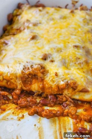 Chili Dog Casserole - 4 Ingredient easy, cheesy dish with hot dogs, chili, and beans. A quick and easy dinner recipe to make over and over again!