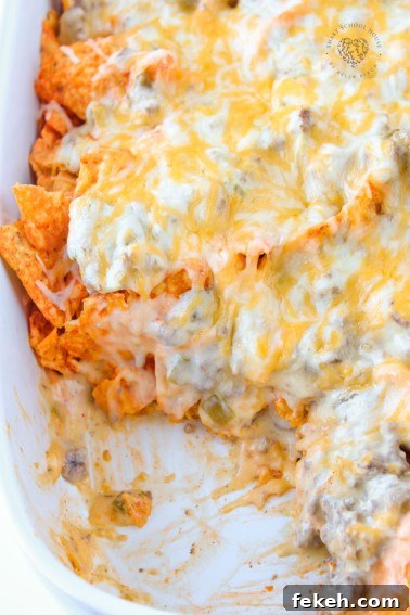This Dorito casserole is layers of crushed Dorito chips, ground beef, and an ooey-gooey cheese sauce. It all gets baked together to melted cheese perfection.