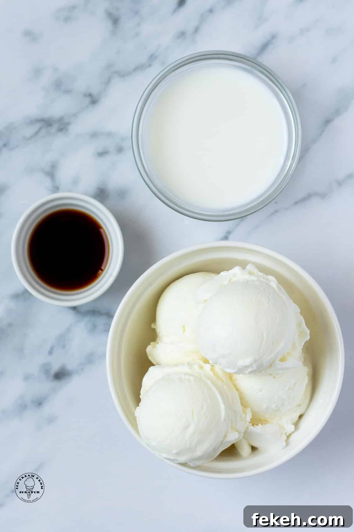 Classic Vanilla Milkshake Recipe: Creamy Homemade Shake in Minutes 3 a bowl of vanilla ice cream, a bowl of milk, and a bowl of vanilla extract on a marble counter, viewed from above