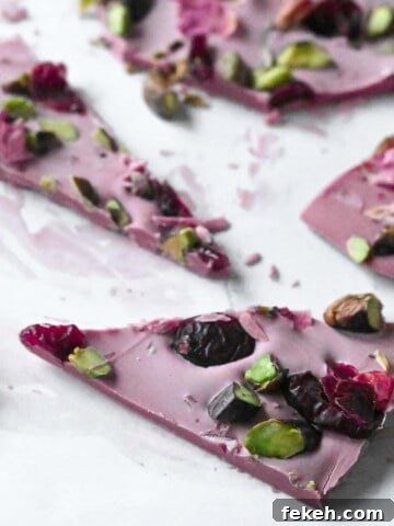 Cut up pieces of ruby chocolate bark on parchment paper.