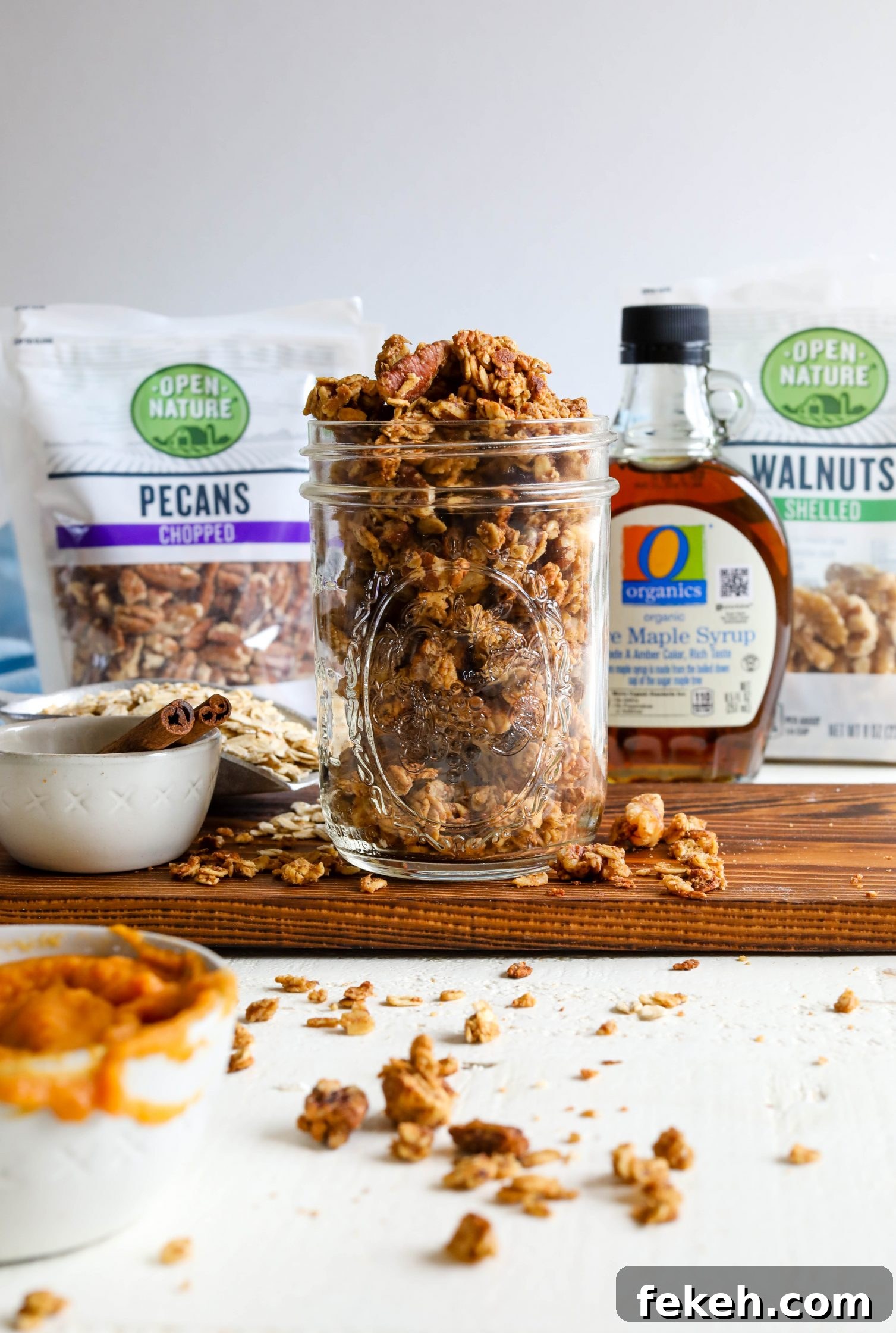 Sweet Potato Spice Granola Recipe for Cozy Fall Mornings 11 Sweet Potato Spice Granola served in mason jar sweet potato puree on the side with blue towel and cinnamon