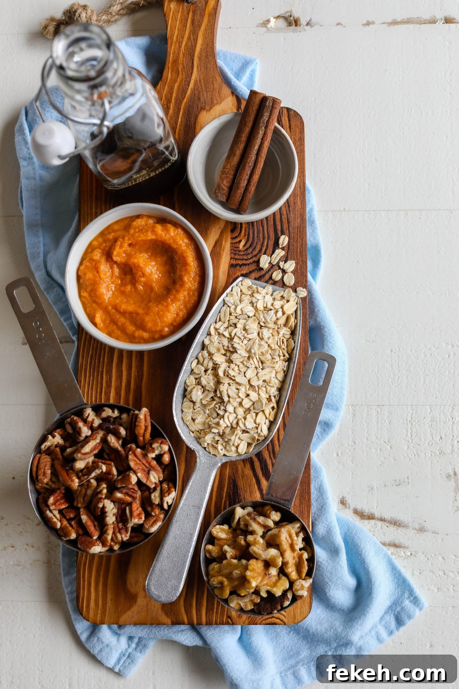 Sweet Potato Spice Granola Recipe for Cozy Fall Mornings 3 ingredients for granola on wooden board with blue towel underneath