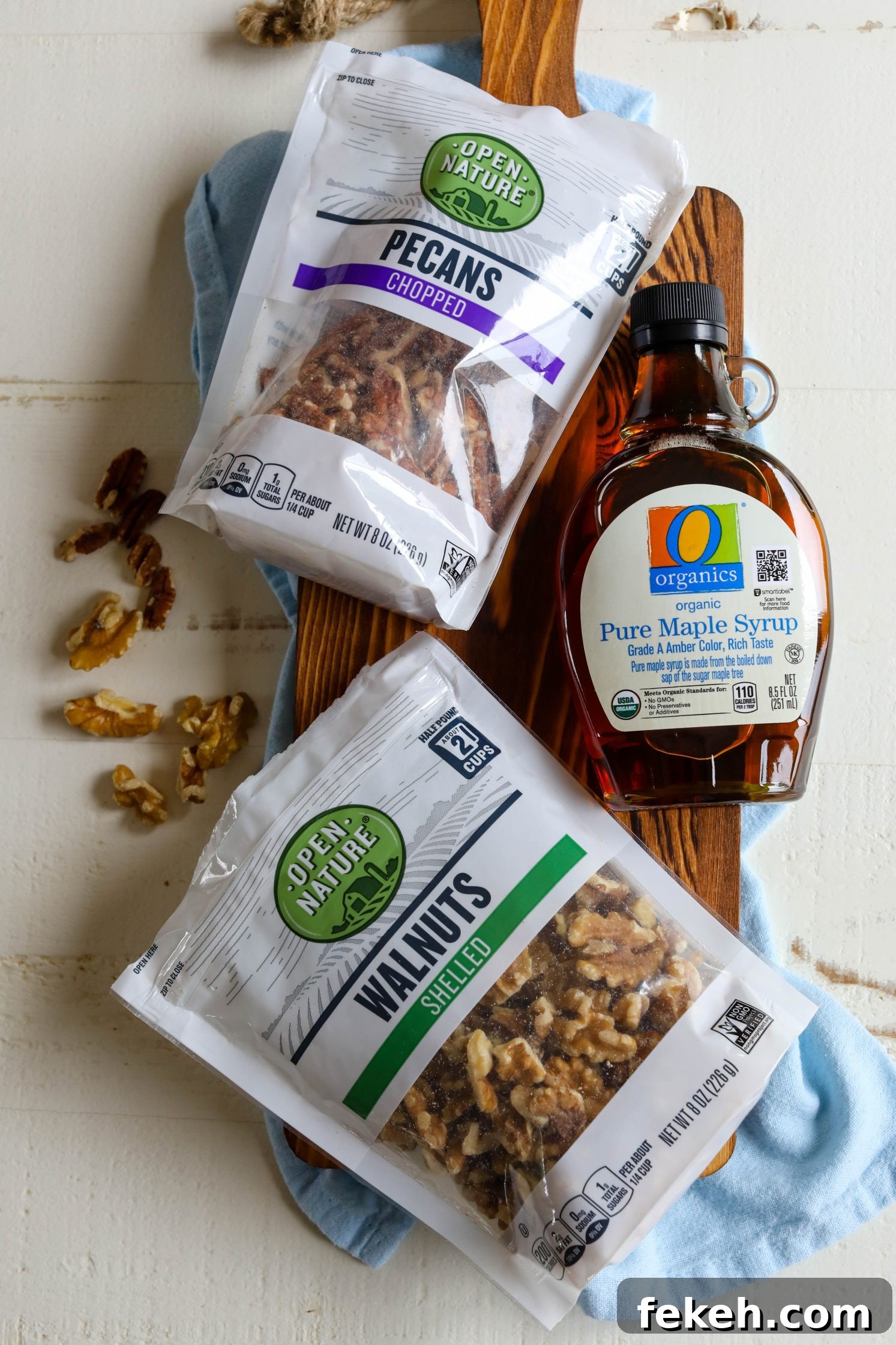 Sweet Potato Spice Granola Recipe for Cozy Fall Mornings 4 O Organics nuts and maple syrup on board with blue towel underneath