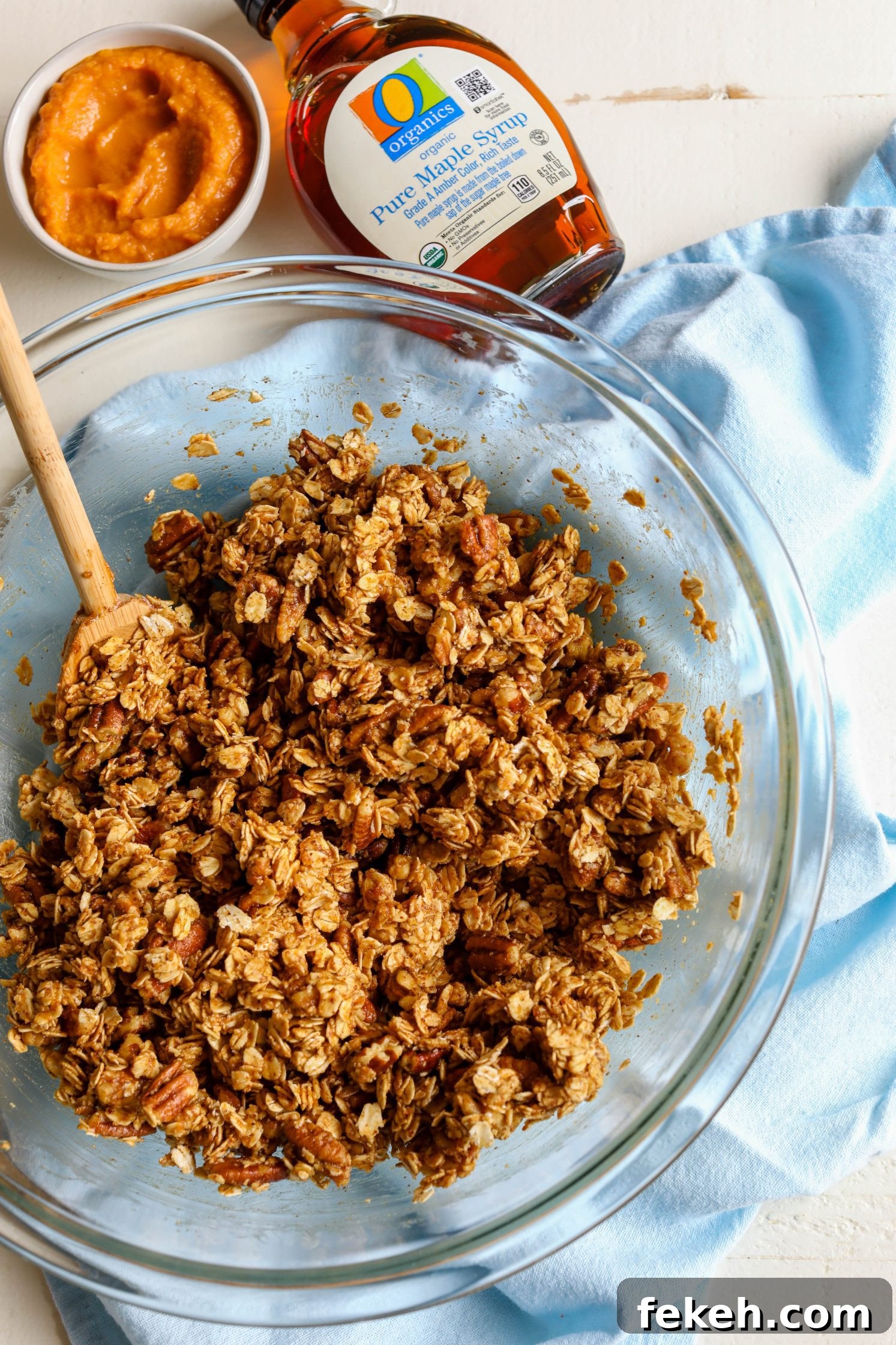 Sweet Potato Spice Granola Recipe for Cozy Fall Mornings 6 Sweet Potato Spice Granola mixed in glass bowl with wooden spoon