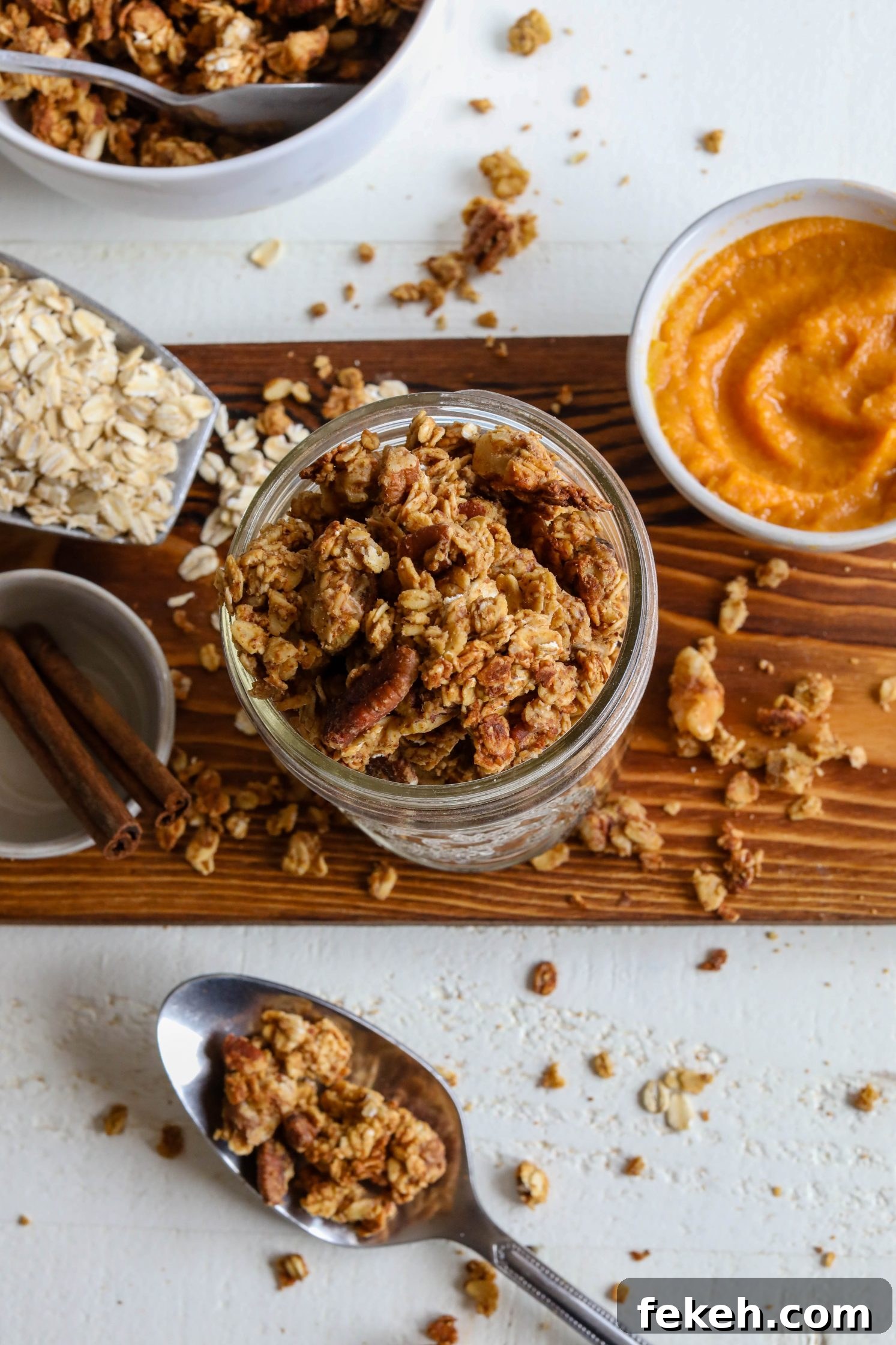 Sweet Potato Spice Granola Recipe for Cozy Fall Mornings 10 Sweet Potato Spice Granola served in mason jar with sweet potato puree on the side with blue towel and cinnamon
