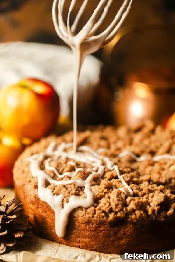 Cardamom Coffee Cake Recipe: Aromatic Spiced Bundt Cake 13 apple coffee cake on a piece of parchment paper with glaze drizzled on top.