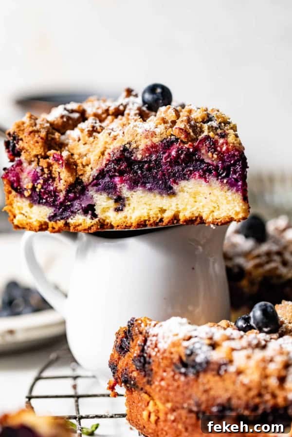 Cardamom Coffee Cake Recipe: Aromatic Spiced Bundt Cake 15 a slice of blueberry coffee cake sitting on top of a small cup.
