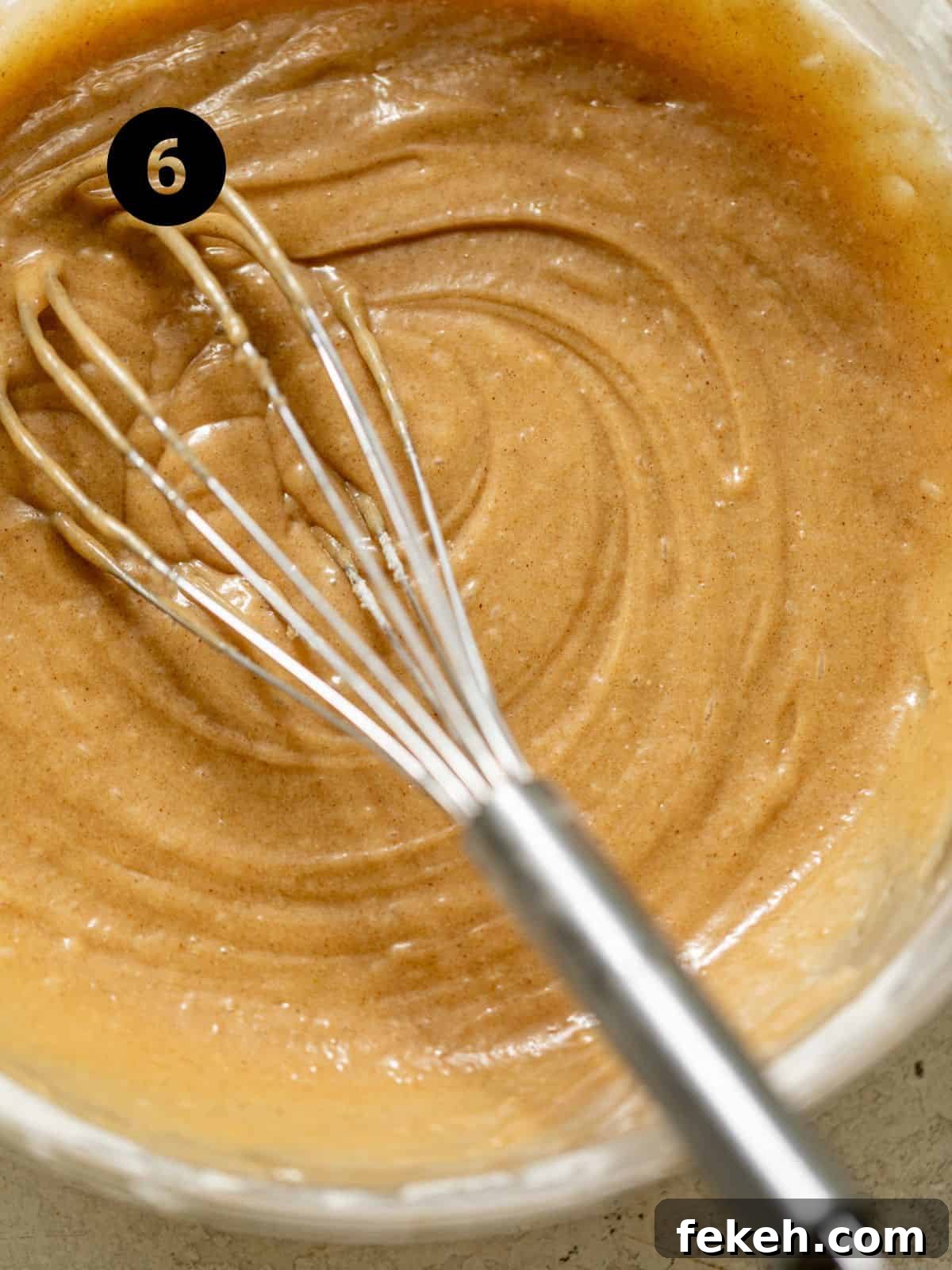 Cardamom Coffee Cake Recipe: Aromatic Spiced Bundt Cake 9 coffee cake batter in a bowl with a whisk.