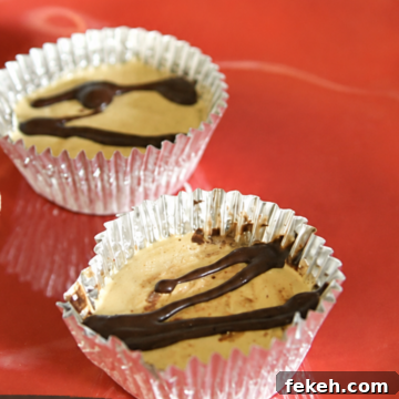 Two peanut butter cups in foil wrappers