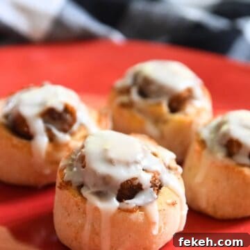 4 small cinnamon rolls on red plate