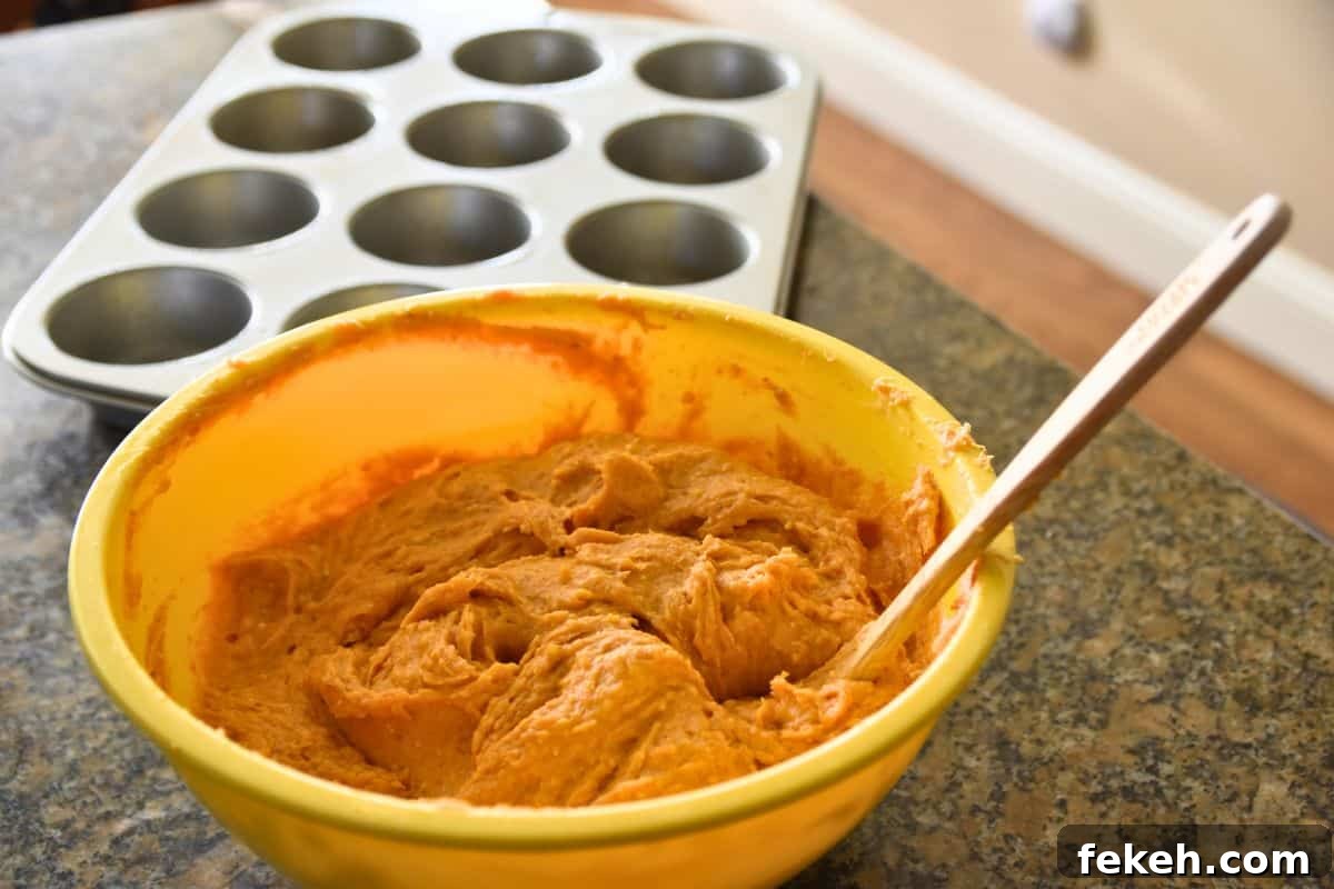 Low-Calorie Pumpkin Muffins for Weight Watchers-Friendly Diet 4 pumpkin muffin batter and muffin pan