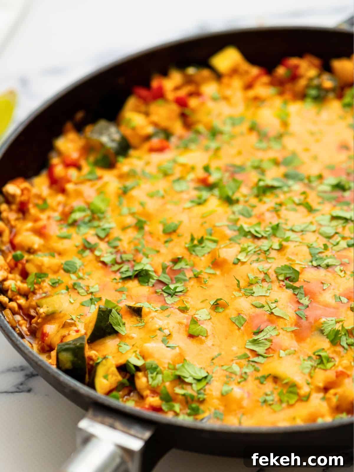 Turkey Taco Skillet Cheesy taco skillet made with lean ground turkey in large skillet topped with cilantro.
