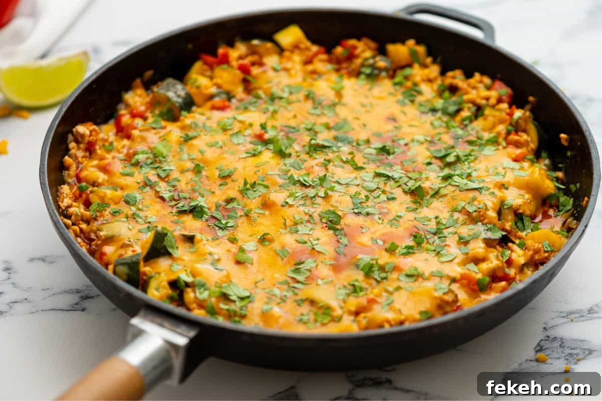 Turkey Taco Recipe Skillet with ground turkey, veggies, smothered in cheese.