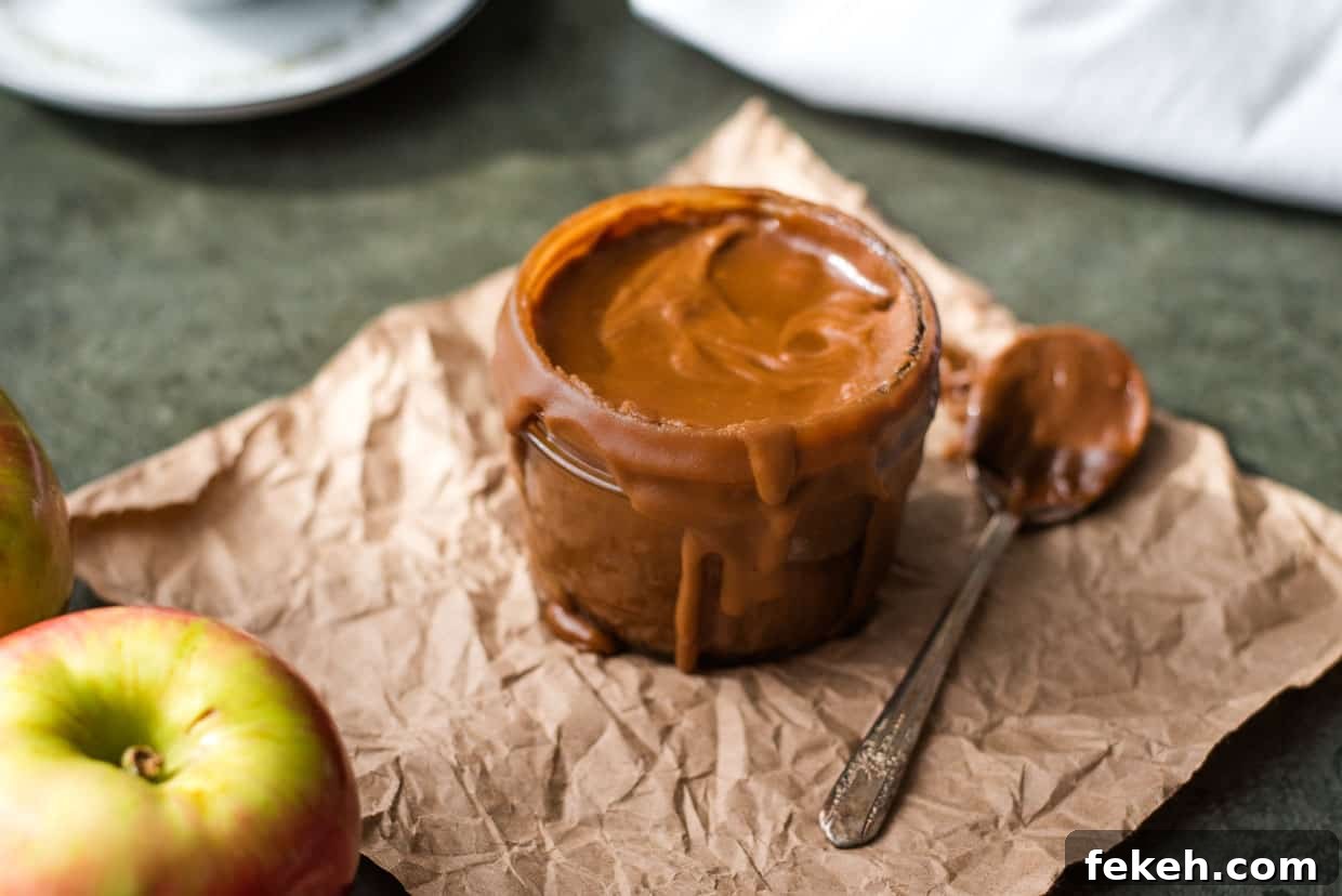 Bourbon butterscotch sauce in a glass jar on brown paper. 