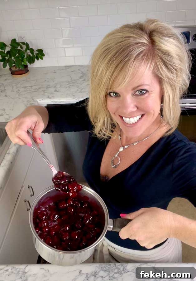 Homemade Cherry Pie Filling Recipe for Fresh, Luscious Pies 3 Jenifer holding a pot of homemade cherry pie filling