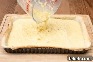 Classic Cheese Flan Recipe: Old-Fashioned Dinner Dessert 16 Pouring the flan mixture into the pastry case