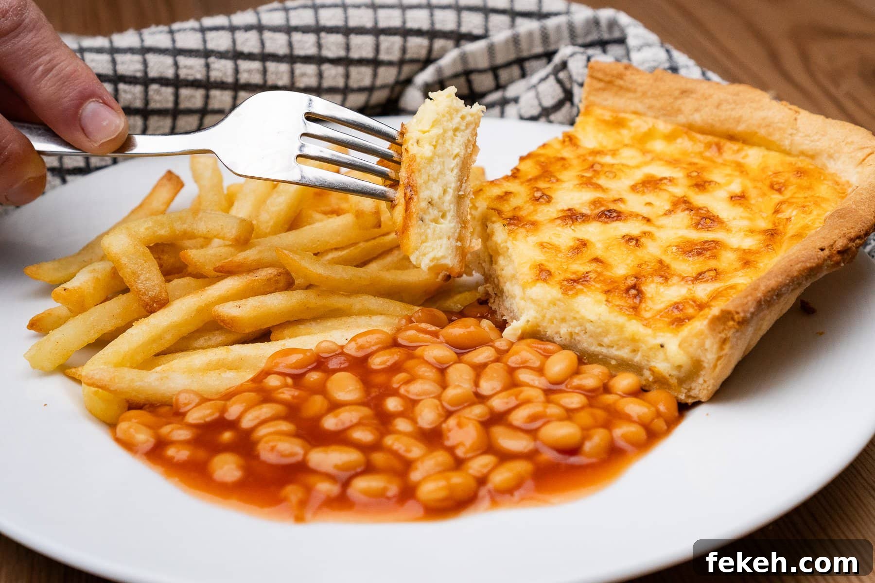 Classic Cheese Flan Recipe: Old-Fashioned Dinner Dessert 24 A piece of cheese flan on a fork with chips and beans