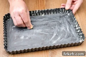 Classic Cheese Flan Recipe: Old-Fashioned Dinner Dessert 6 Greasing a baking tray with butter by hand