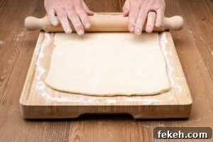 Classic Cheese Flan Recipe: Old-Fashioned Dinner Dessert 7 Rolling out short crust pastry on a wooden board