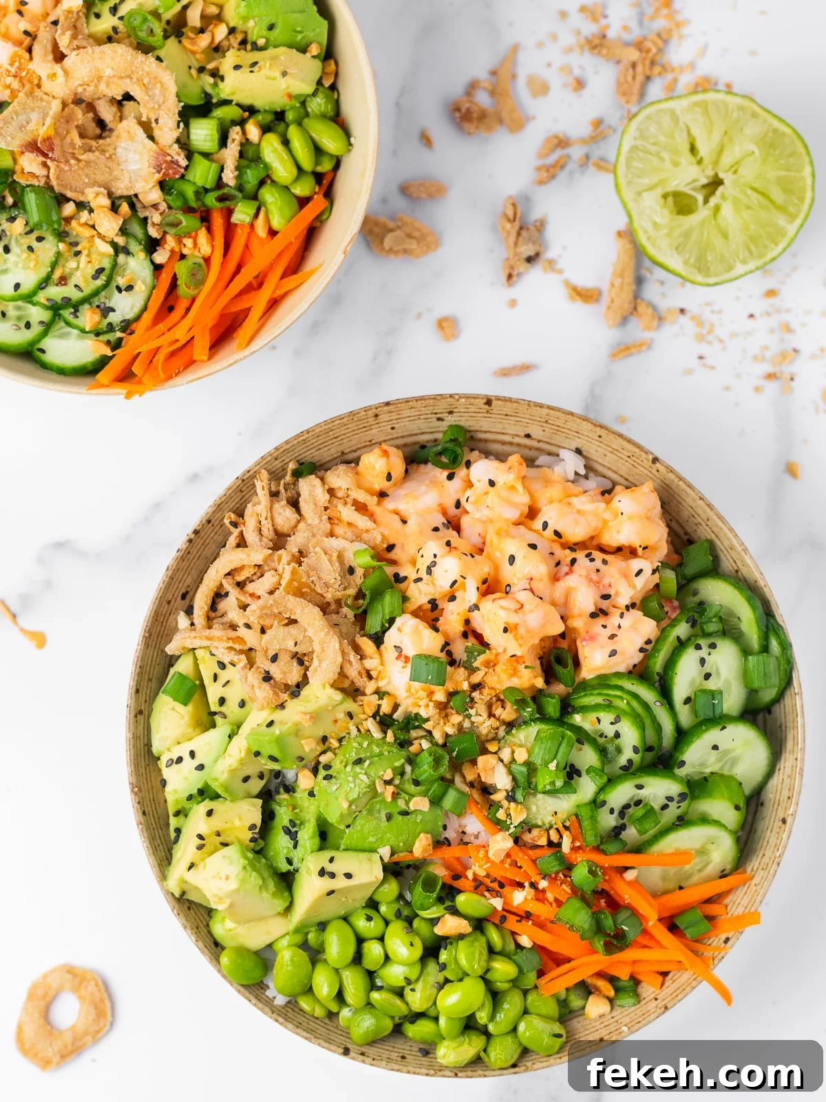 Spicy Shrimp Poke Bowl Recipe with Fresh Mango & Avocado 2 shrimp poke bowl with creamy sweet chili shrimp, crispy onions, avocado, edamame, cucumbers and carrots