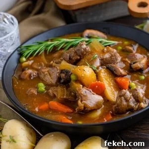 Hearty Venison Stew Recipe for Tender, Flavorful Game Meat 8 Square photo of stew in bowl garnished with rosemary sprig.