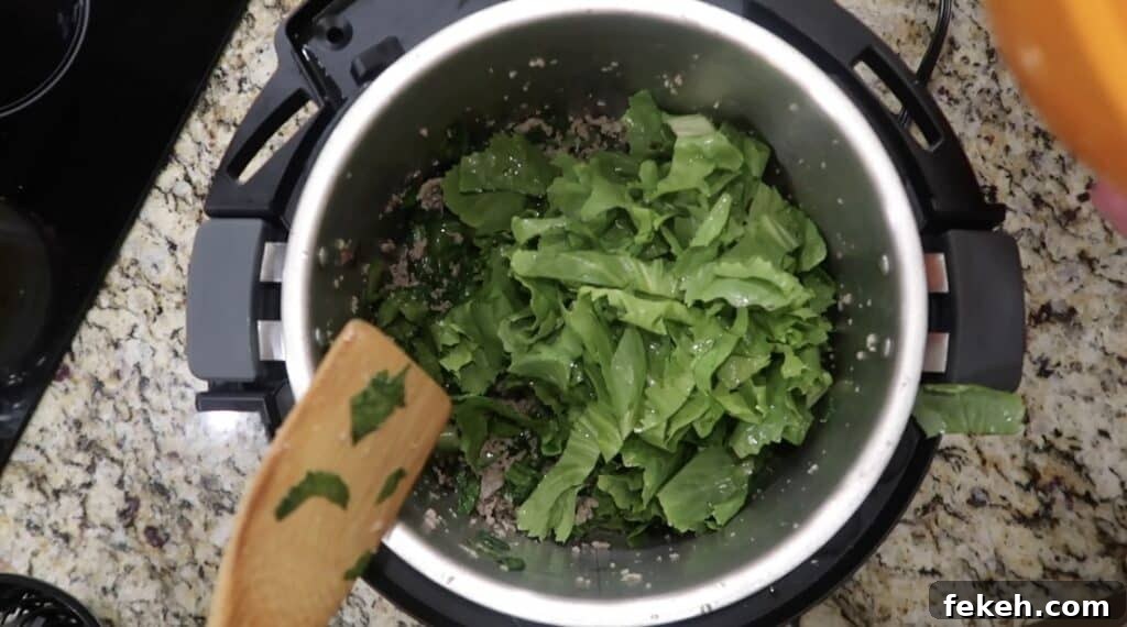 Instant Pot Escarole and White Bean Soup Recipe 12 Adding more escarole to pot