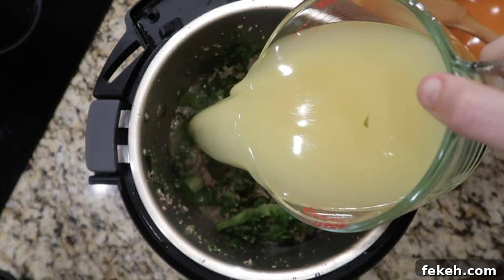 Instant Pot Escarole and White Bean Soup Recipe 14 Adding broth to pot