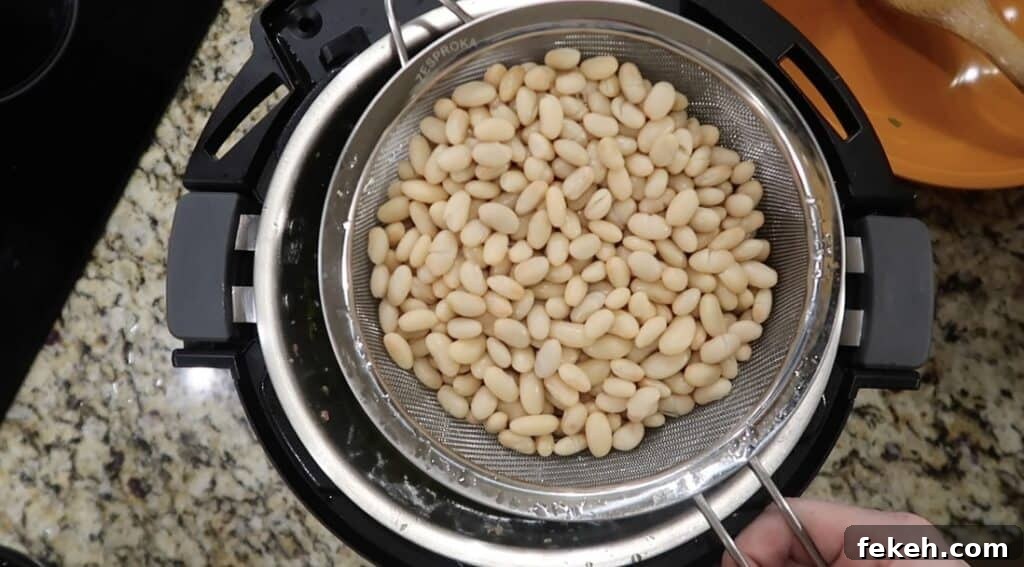 Instant Pot Escarole and White Bean Soup Recipe 17 Adding beans to pot
