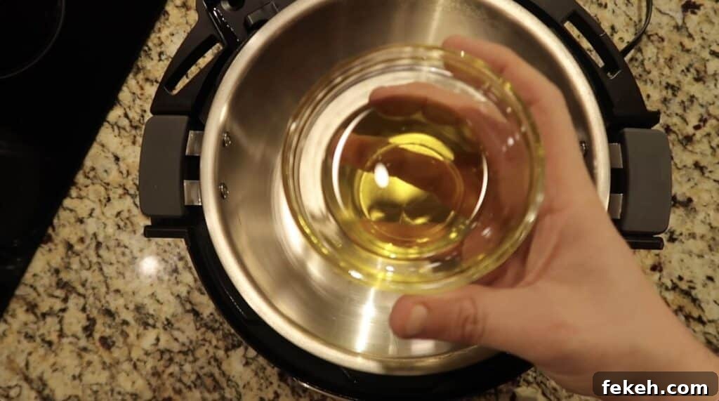 Instant Pot Escarole and White Bean Soup Recipe 5 Add some olive oil to the pot and give it some heat.