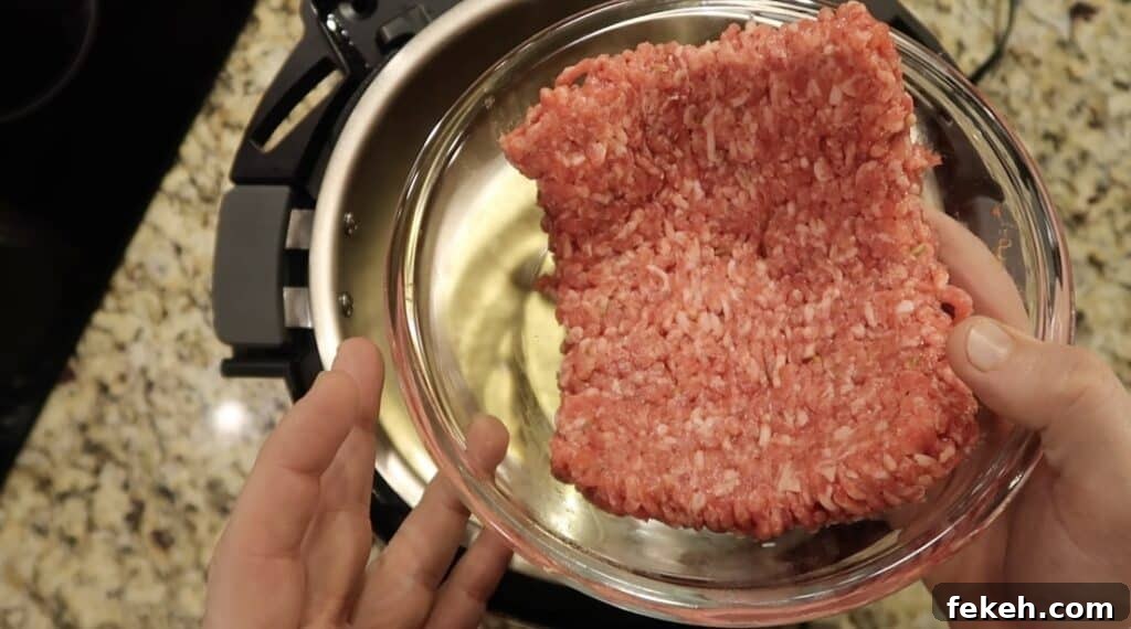 Instant Pot Escarole and White Bean Soup Recipe 6 Adding ground sausage to pot