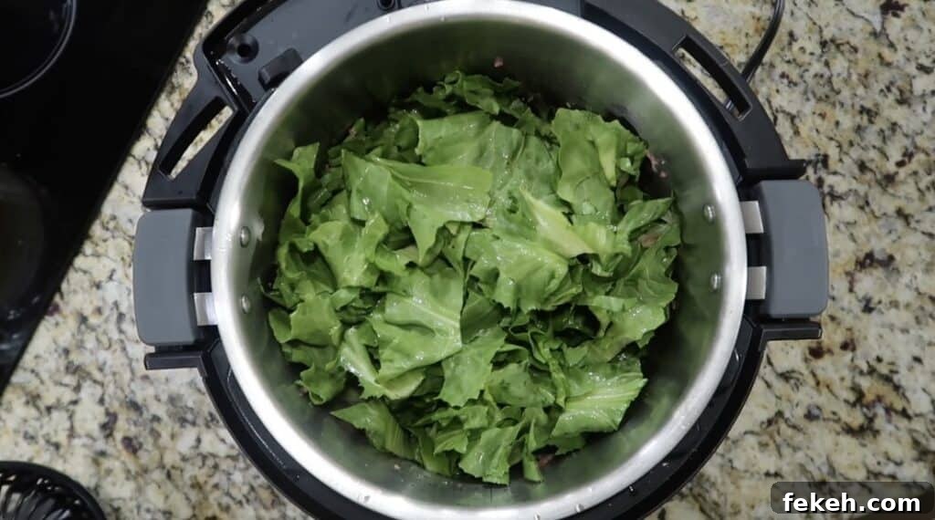 Instant Pot Escarole and White Bean Soup Recipe 8 Adding escarole to pot