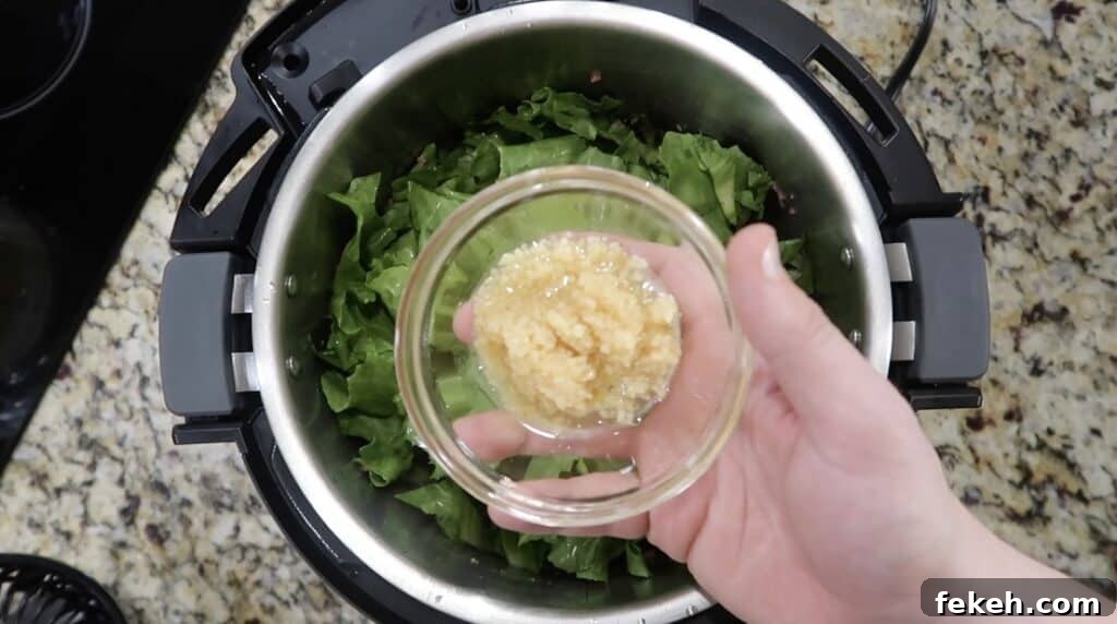 Instant Pot Escarole and White Bean Soup Recipe 9 Adding garlic to pot