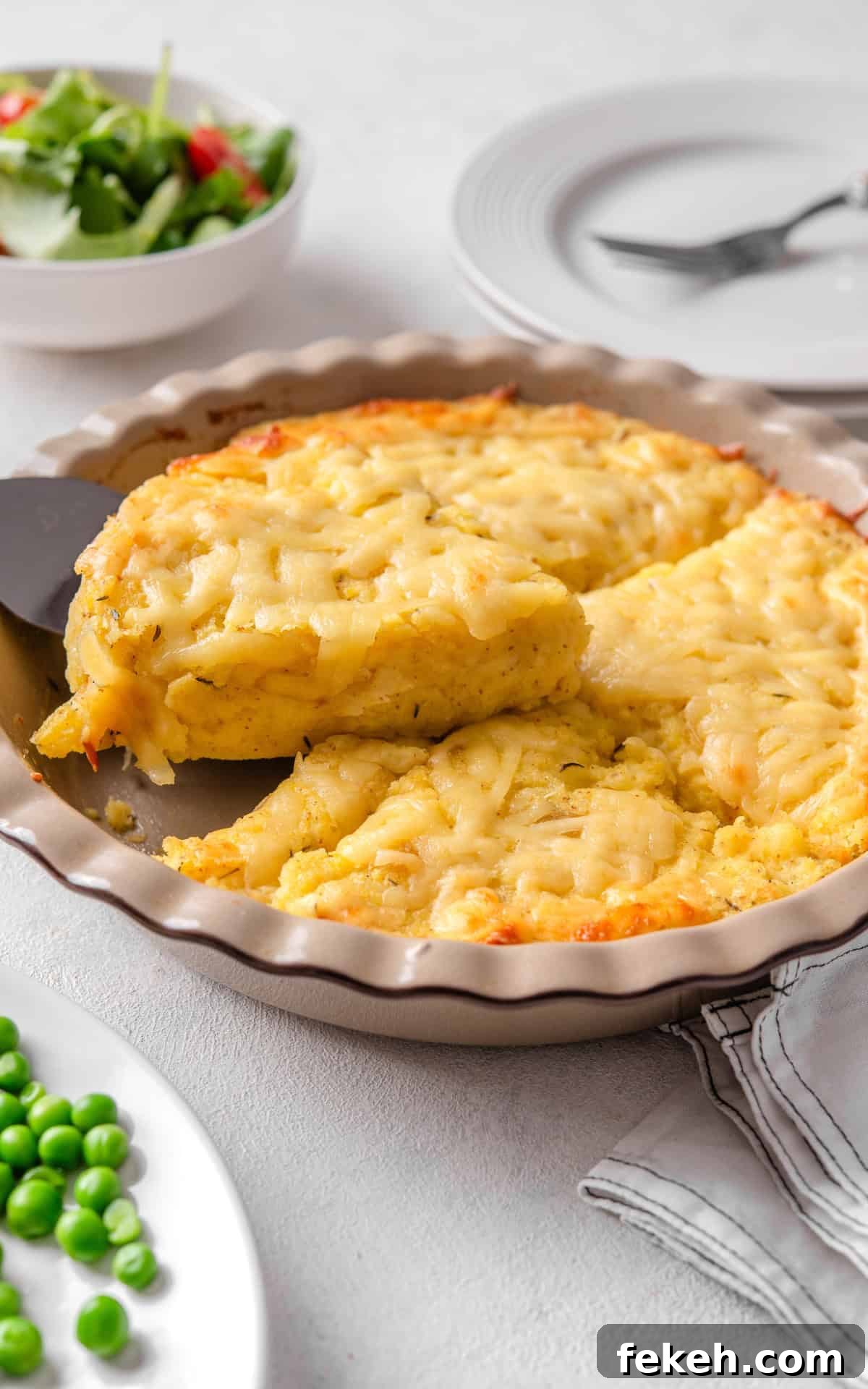 Cheesy Potato Pie Recipe: Crispy Crust & Melty Filling 12 cheesy pie with potatoes in a baking dish.