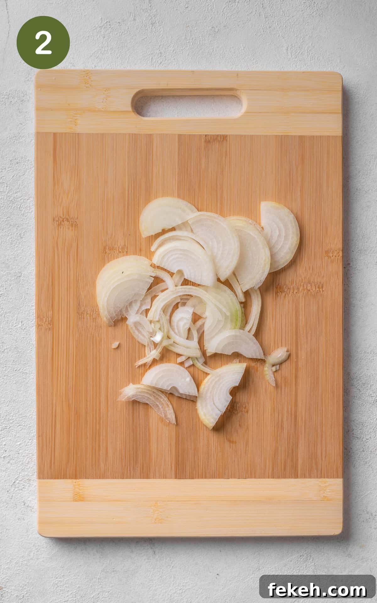 Cheesy Potato Pie Recipe: Crispy Crust & Melty Filling 5 sliced onion on a cutting board.