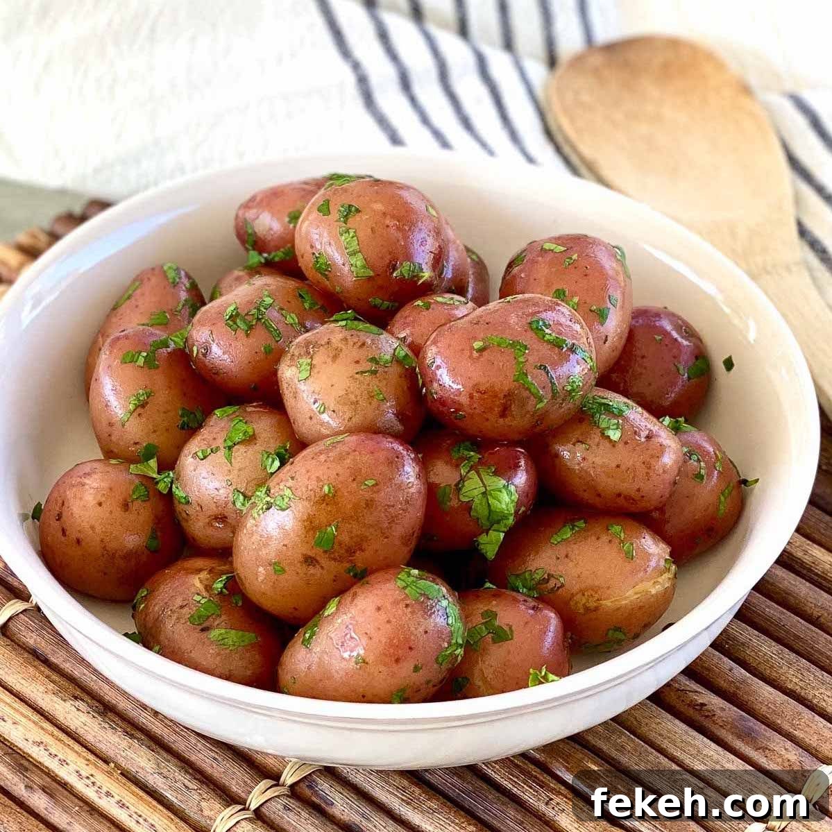 Garlic Butter Boiled Red Potatoes Recipe 2 Bowl of boiled red potatoes coated in butter and garnished with chopped parsley